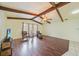 Living room showcases wood beams, wood floors, and large window at 1556 Eagle St, Port Charlotte, FL 33952