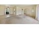 Spacious living room with neutral tile, arched doorways, and sliding glass doors at 1556 Eagle St, Port Charlotte, FL 33952