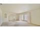 Open living area with neutral walls, arched doorways, and carpeted floors at 1556 Eagle St, Port Charlotte, FL 33952