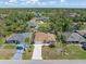 Aerial view of the home in a wooded area with other homes nearby at 16450 Bauers Ave, Port Charlotte, FL 33954