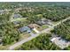 An aerial view of the neighborhood with mature trees and well-maintained homes at 16450 Bauers Ave, Port Charlotte, FL 33954