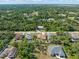 An aerial view of a residential neighborhood surrounded by a lush green forest at 16450 Bauers Ave, Port Charlotte, FL 33954