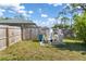 Outdoor water filtration system surrounded by a wood fence in a grassy backyard at 16450 Bauers Ave, Port Charlotte, FL 33954