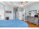 Bedroom featuring wood flooring, tray ceiling, and neutral wall color at 16450 Bauers Ave, Port Charlotte, FL 33954