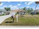 Charming home features manicured lawn and landscaping and stone fire pit at 16450 Bauers Ave, Port Charlotte, FL 33954