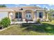 Charming home with manicured landscaping, dual windows, and a covered entryway at 16450 Bauers Ave, Port Charlotte, FL 33954