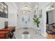 Bright foyer with high ceilings, decorative glass front doors, and tile flooring at 16450 Bauers Ave, Port Charlotte, FL 33954