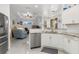 Bright kitchen featuring stainless steel appliances, white cabinets, and a view into the Gathering room at 16450 Bauers Ave, Port Charlotte, FL 33954