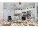 Bright kitchen featuring granite countertops, stainless steel appliances, and white cabinetry at 16450 Bauers Ave, Port Charlotte, FL 33954