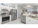 Modern kitchen with stainless steel appliances, granite countertops, and white cabinetry at 16450 Bauers Ave, Port Charlotte, FL 33954