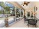 Enclosed lanai with screened windows, ceiling fan, tile floors, and outdoor dining set at 16450 Bauers Ave, Port Charlotte, FL 33954