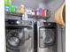 Laundry room with a stainless steel front loading washer and dryer and wire rack shelving above at 16450 Bauers Ave, Port Charlotte, FL 33954
