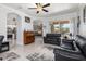 Open-concept living room featuring neutral paint, ceiling fan, and sliding glass doors to the outdoor patio at 16450 Bauers Ave, Port Charlotte, FL 33954