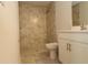 Bathroom featuring tiled shower, a toilet, and vanity with modern sink fixtures at 17374 Gadsen Ave, Port Charlotte, FL 33948