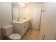 Bathroom with double sink vanity with quartz countertop and separate toilet room at 17374 Gadsen Ave, Port Charlotte, FL 33948
