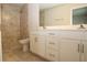 Modern bathroom with tiled walk-in shower and white vanity with quartz countertop at 17374 Gadsen Ave, Port Charlotte, FL 33948