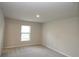 Spacious bedroom with neutral carpet, paint, and a window for natural light at 17374 Gadsen Ave, Port Charlotte, FL 33948