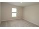 Bright bedroom features neutral carpet and a window providing natural light at 17374 Gadsen Ave, Port Charlotte, FL 33948