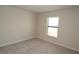 Simple yet cozy bedroom with a single window and soft carpeting at 17374 Gadsen Ave, Port Charlotte, FL 33948