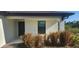 Welcoming front entrance featuring a dark-colored door, and natural colored landscaping at 17374 Gadsen Ave, Port Charlotte, FL 33948