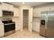 Modern kitchen features stainless steel appliances, quartz counters, white cabinetry, and a pantry at 17374 Gadsen Ave, Port Charlotte, FL 33948
