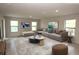 Bright living room featuring neutral walls, multiple windows, and contemporary furnishings at 17374 Gadsen Ave, Port Charlotte, FL 33948