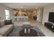 Open-concept living room showcasing modern finishes and seamless flow to the kitchen and dining area at 17374 Gadsen Ave, Port Charlotte, FL 33948