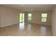 Bright living room with sliding glass doors, tile floors, and neutral colored walls at 17374 Gadsen Ave, Port Charlotte, FL 33948