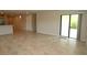 Large living room with a sliding glass door and access to kitchen area at 17374 Gadsen Ave, Port Charlotte, FL 33948