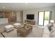 Bright living room with comfortable seating, large screen TV, and open access to other areas of the home at 17374 Gadsen Ave, Port Charlotte, FL 33948