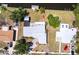 Aerial view of a charming home with a well-maintained yard, lush trees, and convenient street access at 182 Dowling Ne Ave, Port Charlotte, FL 33952