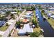 Waterfront home with a canal and boat dock, with a beautiful blue bay visible in the background at 182 Dowling Ne Ave, Port Charlotte, FL 33952