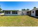 Spacious backyard with a pergola-covered patio and plenty of space for outdoor activities at 182 Dowling Ne Ave, Port Charlotte, FL 33952