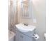 Clean bathroom with a shower-tub combo, tiled walls, a toilet paper holder and a gray single sink vanity at 182 Dowling Ne Ave, Port Charlotte, FL 33952