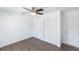 Cozy bedroom featuring wood-look floors and convenient access to closet and doorway at 182 Dowling Ne Ave, Port Charlotte, FL 33952