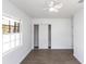 Bedroom featuring hardwood floors, a ceiling fan, closet with sliding doors, and a bright window at 182 Dowling Ne Ave, Port Charlotte, FL 33952