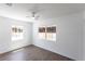 Bright bedroom with hardwood floors, two windows, and a ceiling fan, offering a simple and modern living space at 182 Dowling Ne Ave, Port Charlotte, FL 33952