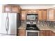 Close up of the kitchen's stainless steel appliances and the granite countertops at 182 Dowling Ne Ave, Port Charlotte, FL 33952