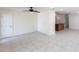 Open living area featuring tile flooring, ceiling fan, plus view into other living space at 182 Dowling Ne Ave, Port Charlotte, FL 33952