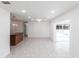 Bright, spacious living room with tile floors, recessed lighting, and views into the sun room at 182 Dowling Ne Ave, Port Charlotte, FL 33952