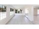 Inviting sunroom with tiled floors and large windows, leading into multiple areas of the home at 182 Dowling Ne Ave, Port Charlotte, FL 33952