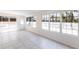Bright sunroom featuring large windows offering serene views of the waterfront and a tiled floor at 182 Dowling Ne Ave, Port Charlotte, FL 33952
