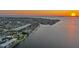 Breathtaking aerial view of the waterfront property, nestled on a tranquil canal with sunset backdrop at 1820 Jamaica Way, Punta Gorda, FL 33950