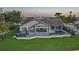 Aerial view of a home with a pool and patio area that has comfortable seating and lawn at 1820 Jamaica Way, Punta Gorda, FL 33950