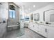 Modern bathroom with a spacious glass shower, dual sinks, and sleek white cabinets at 1820 Jamaica Way, Punta Gorda, FL 33950