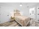 Bright bedroom with a floral bedspread, wood flooring, and white ceiling fan at 1820 Jamaica Way, Punta Gorda, FL 33950