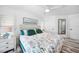 Stylish bedroom featuring a decorative ceiling fan, light wood flooring and coastal decor at 1820 Jamaica Way, Punta Gorda, FL 33950