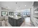 Bright, open kitchen featuring a large island, modern lighting, and water views at 1820 Jamaica Way, Punta Gorda, FL 33950