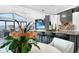 Modern kitchen with bar seating, stainless steel appliances and open access to dining and living spaces at 1820 Jamaica Way, Punta Gorda, FL 33950