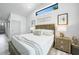 Bright main bedroom features vaulted ceiling, transom window, and stylish coastal decor at 1820 Jamaica Way, Punta Gorda, FL 33950